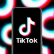 Tiktok's logo displayed on a phone